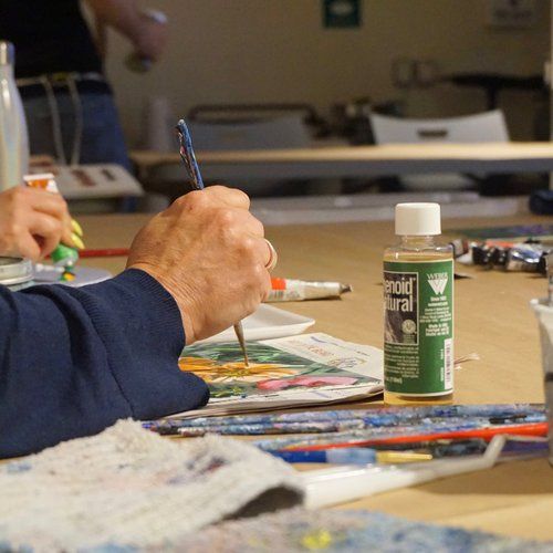 Hand holding a paintbrush